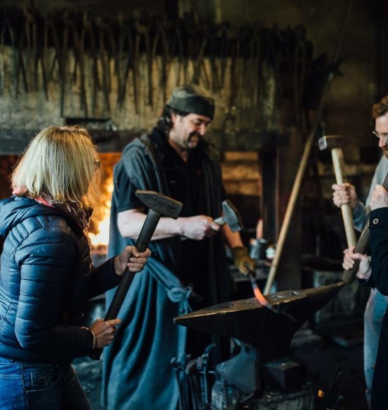 4 Personen schmieden zusammen